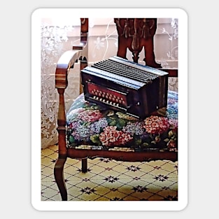 Button Accordion on Chair With Flowered Seat Sticker